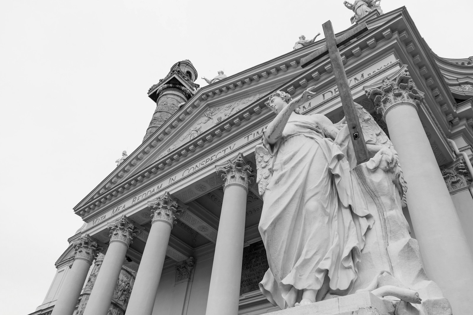 a black and white photo of a statue in front of a building